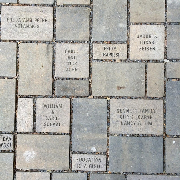 Pavers with the names of people who have given donations.