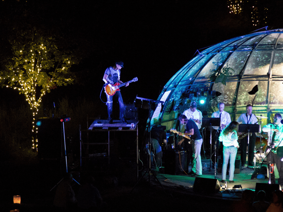 A concert taking place at the Patricia McCain Outdoor Amphitheater