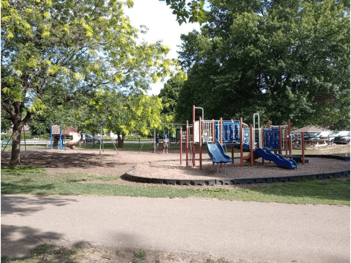 enclosed playground with two main playsets